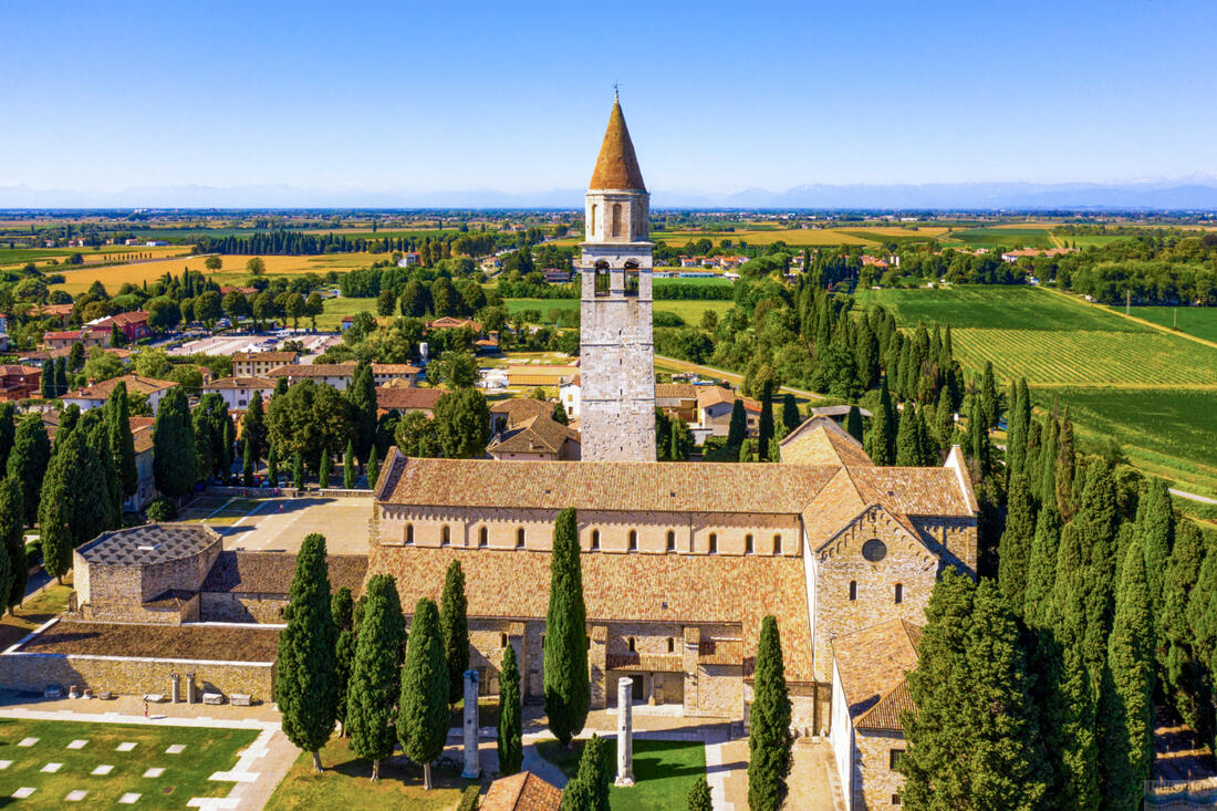 Scenic aerial view of small Italian city of Aquileia and ancient Patriarchal Basilica di Santa Maria Assunta