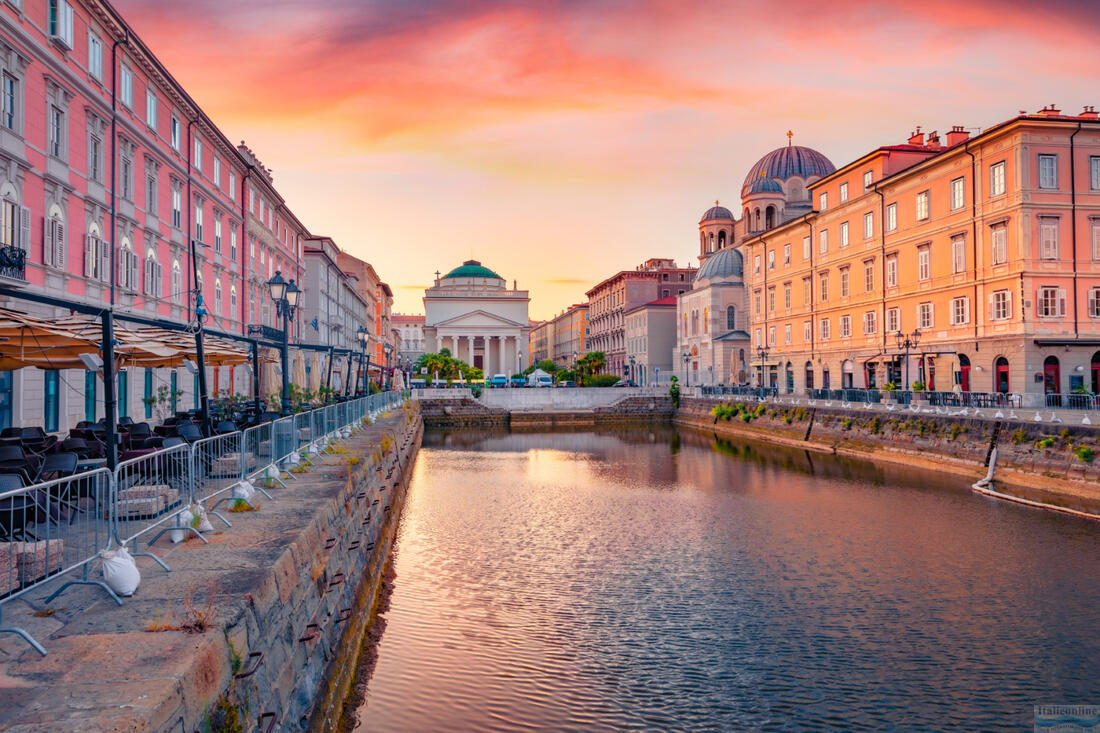 Gorgeous morning view of Canal Grande di Trieste and Church of SantAntonio Nuovo on background