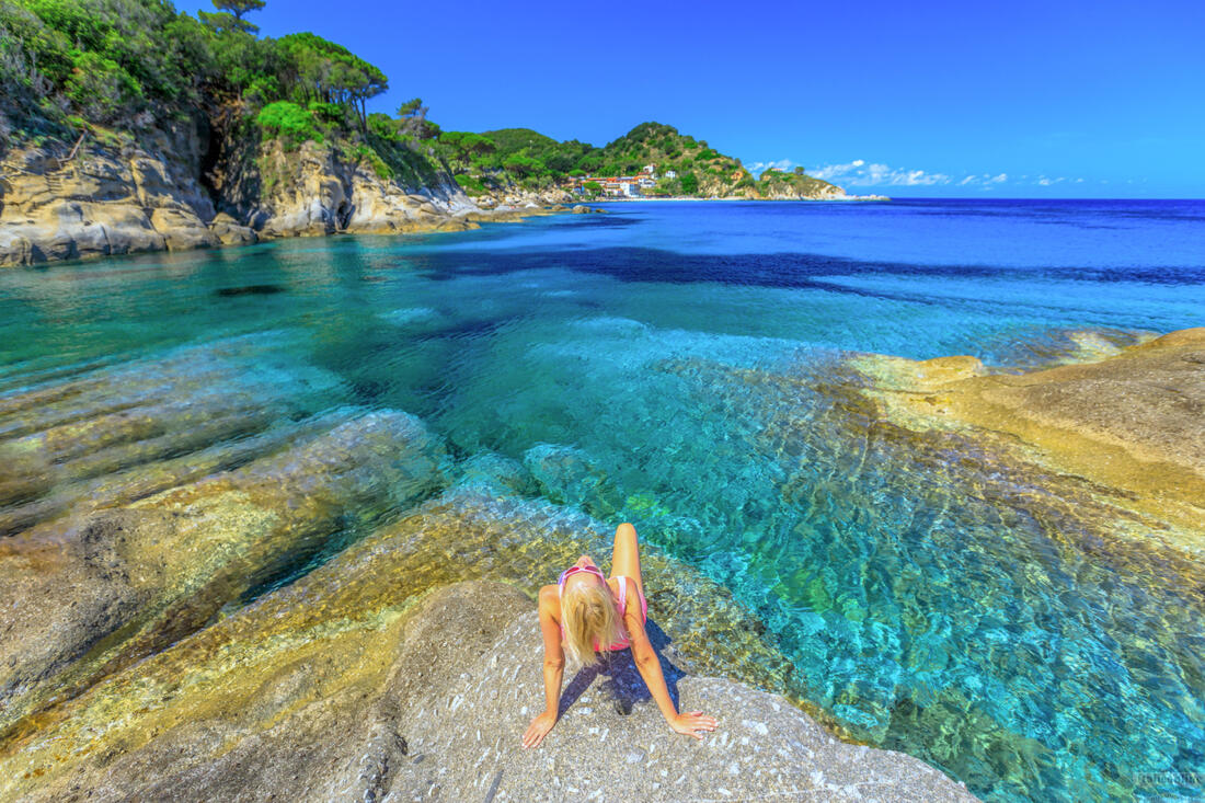 Woman sunbathing on Cotoncello beach, Elba