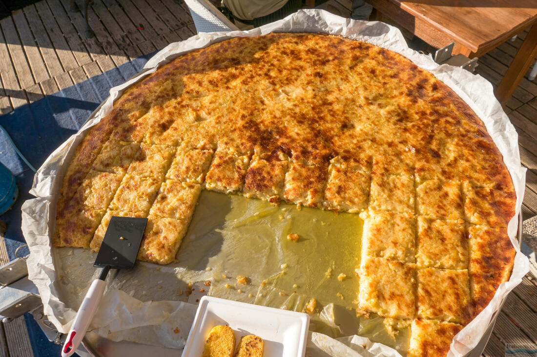 A huge pan with Frico, a typical Friulian dish of onions, potatoes and Montasio cheese